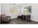 Well-lit room features gray toned wood floors and a cozy armchair at 12332 Switchgrass Ave, Las Vegas, NV 89138