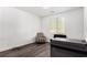 Bright room with gray toned wood floors, natural light, and seating arrangement at 12332 Switchgrass Ave, Las Vegas, NV 89138