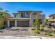 Modern two-story home featuring a three-car garage and well-maintained front yard landscaping at 12332 Switchgrass Ave, Las Vegas, NV 89138