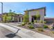 Modern home with desert landscaping, three-car garage, and a welcoming stone-accented entrance at 12332 Switchgrass Ave, Las Vegas, NV 89138