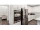 Modern kitchen featuring stainless steel appliances and white cabinetry with dark-toned flooring at 12332 Switchgrass Ave, Las Vegas, NV 89138