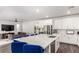 Open-concept kitchen featuring a marble island, white cabinets, and seamless flow to the living area at 12332 Switchgrass Ave, Las Vegas, NV 89138
