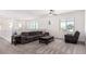 Upstairs living room features a plush couch, cozy armchair, and neutral carpeting at 12332 Switchgrass Ave, Las Vegas, NV 89138