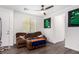 Inviting living room with brown sofa, wood floors, and contemporary decor at 12332 Switchgrass Ave, Las Vegas, NV 89138