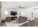 Elegant living room boasts modern decor, a ceiling fan, and plenty of natural light at 12332 Switchgrass Ave, Las Vegas, NV 89138