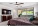 Spacious bedroom with ceiling fan, balcony access, and neutral carpeting at 12332 Switchgrass Ave, Las Vegas, NV 89138