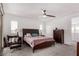 Bedroom featuring a ceiling fan, large bed, balcony access, and neutral carpeting at 12332 Switchgrass Ave, Las Vegas, NV 89138