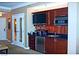This kitchenette features wood cabinetry, stainless steel appliances, and black countertops at 125 E Harmon Ave # 1918, Las Vegas, NV 89109