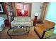Cozy living room with a comfortable sofa, stylish armchair, and chic glass-top coffee table at 125 E Harmon Ave # 1918, Las Vegas, NV 89109