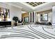 Spacious lobby with patterned tile floors, lounge seating, modern decor, and ample natural light at 125 E Harmon Ave # 1918, Las Vegas, NV 89109