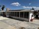 Backyard image showing extended enclosed patio area ready for renovation with a clear sky at 1674 Seneca Ln, Las Vegas, NV 89169