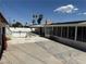 Long shot of backyard with a pool and enclosed patio with home and blue sky in the background at 1674 Seneca Ln, Las Vegas, NV 89169