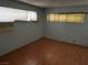 A bedroom featuring laminate floors and window coverings at 1674 Seneca Ln, Las Vegas, NV 89169