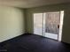Bedroom with a sliding door leading to an enclosed outdoor space and dark carpeting at 1674 Seneca Ln, Las Vegas, NV 89169
