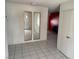 A bright entry featuring tile flooring, neutral walls, and mirrored closet doors at 1674 Seneca Ln, Las Vegas, NV 89169
