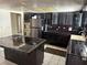 An open kitchen with black cabinets, tile countertops, and stainless steel appliances at 1674 Seneca Ln, Las Vegas, NV 89169