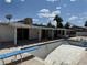 Backyard pool with diving board and steps, ready for renovation with home in background and blue sky at 1674 Seneca Ln, Las Vegas, NV 89169