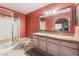 This updated bathroom features a glass-enclosed shower and dual granite vanity for a luxurious feel at 1812 N Decatur Blvd # 103, Las Vegas, NV 89108