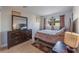 Traditional-style bedroom with warm lighting, dark wood furniture, and tiled floor with a decorative rug at 1812 N Decatur Blvd # 103, Las Vegas, NV 89108