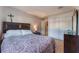Neutral-toned bedroom features a large bed, tiled floors, and an ample closet space at 1812 N Decatur Blvd # 103, Las Vegas, NV 89108