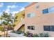 Apartment building exterior with landscaped entrance and convenient stairwell access under a sunny sky at 1812 N Decatur Blvd # 103, Las Vegas, NV 89108