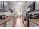 Bright kitchen with stainless steel appliances, granite countertops, and a dining area at 1812 N Decatur Blvd # 103, Las Vegas, NV 89108