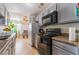 Bright kitchen with stainless steel appliances, granite countertops, and a dining area at 1812 N Decatur Blvd # 103, Las Vegas, NV 89108