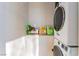 Laundry area featuring stacked washer/dryer set with convenient storage shelves for detergents and supplies at 1812 N Decatur Blvd # 103, Las Vegas, NV 89108