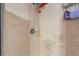 Close-up of a tiled shower showcasing the showerhead, handle and tiled walls at 1812 N Decatur Blvd # 103, Las Vegas, NV 89108