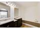 Bathroom featuring double sinks, granite countertops, and a soaking tub at 1846 N Decatur Blvd # 104, Las Vegas, NV 89108