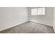 A cozy bedroom with plush gray carpet and a window at 1846 N Decatur Blvd # 104, Las Vegas, NV 89108