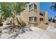 Apartment building exterior featuring private stairs and landscaping, under a clear blue sky at 1846 N Decatur Blvd # 104, Las Vegas, NV 89108