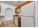 Compact kitchen featuring granite countertops, white appliances, and ample cabinet storage at 1846 N Decatur Blvd # 104, Las Vegas, NV 89108