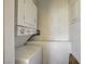 Compact laundry area featuring a stacked washer and dryer unit at 1846 N Decatur Blvd # 104, Las Vegas, NV 89108