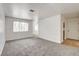 Spacious living room with plush carpeting, base trim, and a bright neutral color palette at 1846 N Decatur Blvd # 104, Las Vegas, NV 89108
