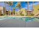 A pristine pool with clear water and palm trees reflecting on the surface of apartments at 1846 N Decatur Blvd # 104, Las Vegas, NV 89108