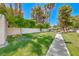 A well-maintained backyard features a lush green lawn and a peaceful walkway at 2101 Plaza Del Fuentes, Las Vegas, NV 89102
