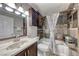 A full bath offers a vanity with a marble countertop and a tub and shower combination at 2101 Plaza Del Fuentes, Las Vegas, NV 89102