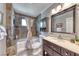 This bathroom features a combination tub and shower, a vanity with marble countertop, and decorative tile at 2101 Plaza Del Fuentes, Las Vegas, NV 89102