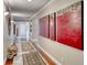 Long hallway featuring hardwood floors, multiple doorways, neutral paint and decorative art at 2101 Plaza Del Fuentes, Las Vegas, NV 89102