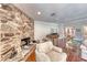Inviting living room featuring hardwood floors, stone fireplace, and cozy seating area at 2101 Plaza Del Fuentes, Las Vegas, NV 89102