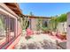 Cozy patio area with red cushioned chair and numerous potted cacti at 2101 Plaza Del Fuentes, Las Vegas, NV 89102