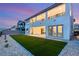 Stunning modern home showcasing a pristine backyard with artificial lawn and desert landscaping at 230 Cactus Sunrise St, Las Vegas, NV 89138