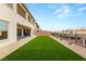 Expansive backyard with artificial turf, offering a lush and inviting space for relaxation and entertainment at 230 Cactus Sunrise St, Las Vegas, NV 89138