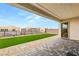 Relaxing backyard with a patio, artificial turf, and stone accents, perfect for outdoor entertaining at 230 Cactus Sunrise St, Las Vegas, NV 89138