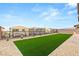 Beautifully landscaped backyard with artificial turf, providing a maintenance-free outdoor space at 230 Cactus Sunrise St, Las Vegas, NV 89138