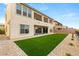 Spacious backyard featuring artificial turf, ideal for outdoor activities and low-maintenance living at 230 Cactus Sunrise St, Las Vegas, NV 89138