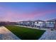 Inviting backyard with a well-manicured lawn, rock landscaping, and privacy fence, perfect for entertaining at 230 Cactus Sunrise St, Las Vegas, NV 89138