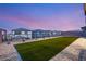 Lush artificial turf lawn and desert rock landscaping create a serene and low-maintenance backyard setting at 230 Cactus Sunrise St, Las Vegas, NV 89138