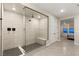 Bright bathroom featuring a modern walk-in shower with sleek glass enclosure and bench at 230 Cactus Sunrise St, Las Vegas, NV 89138